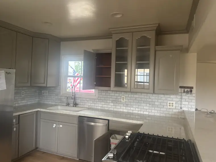 Finished kitchen with gray cabinets before demolition