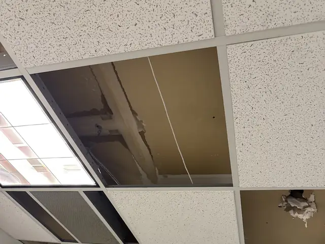 Water-damaged ceiling tiles removed from an office ceiling